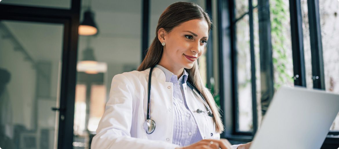 A doctor working on a computer