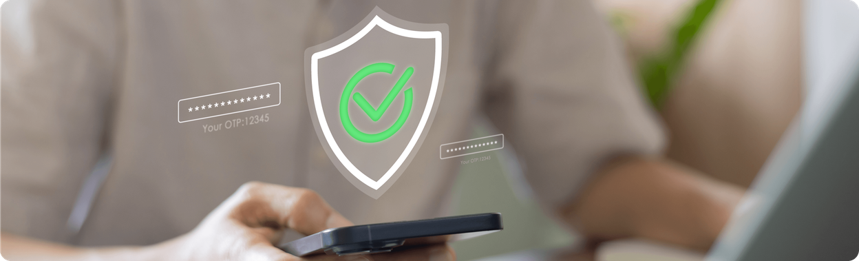Person using a smartphone with a shield and checkmark icon above it, representing secure one-time password verification